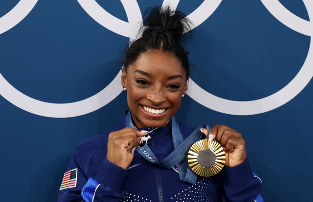 Simone Biles Stuns the World with Gold Medal Win and Bold GOAT Necklace!